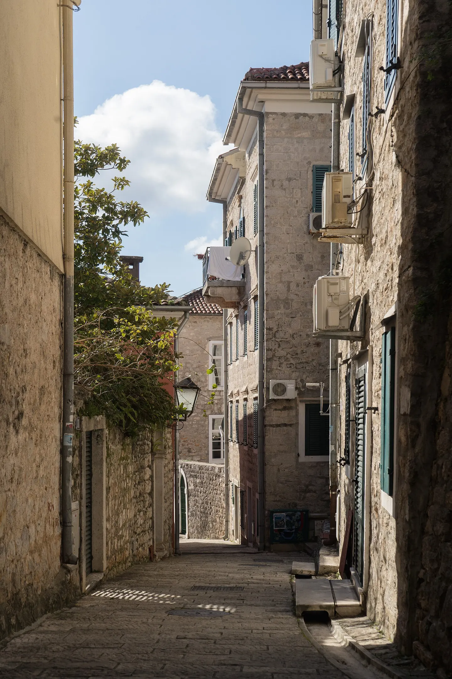 Narrow stone street between houses in Herceg Novi Old Town